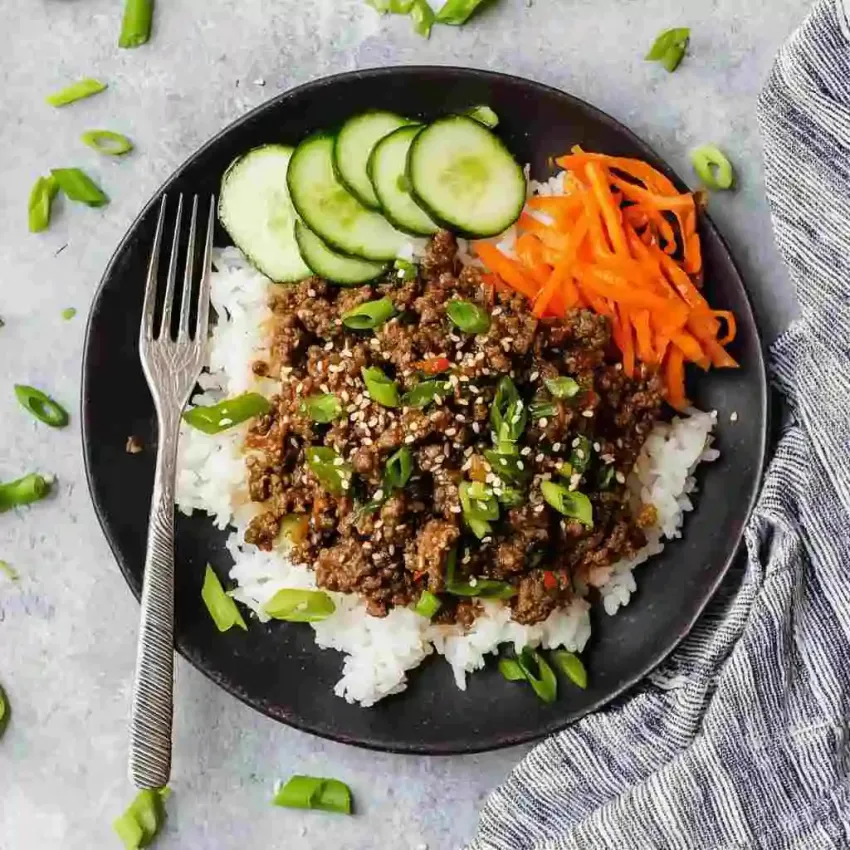 Hot honey beef bowl in Korean style with toppings and soft-boiled egg