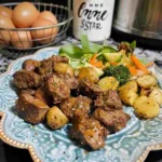 Garlic Butter Steak Bites Crockpot with Potatoes served with herbs